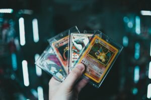 A hand holds collectible Charizard Chinese PTCG Pokemon cards with a blurred bokeh background. Perfect for trading card enthusiasts.